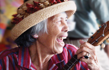 native woman playing an instrument