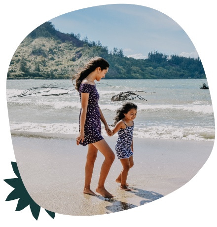 Two girls walking on a beach