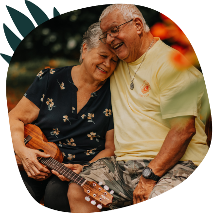 Mature couple embracing while holding a ukulele 